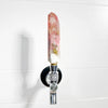 Decorative beer tap with a pink crystal handle on a white background