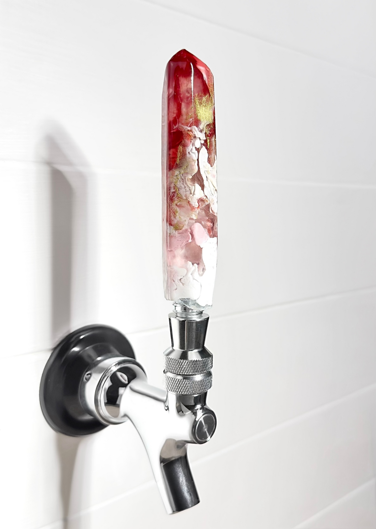 Handmade red, gold, pink, and white resin beer tap handle in a crystal shape