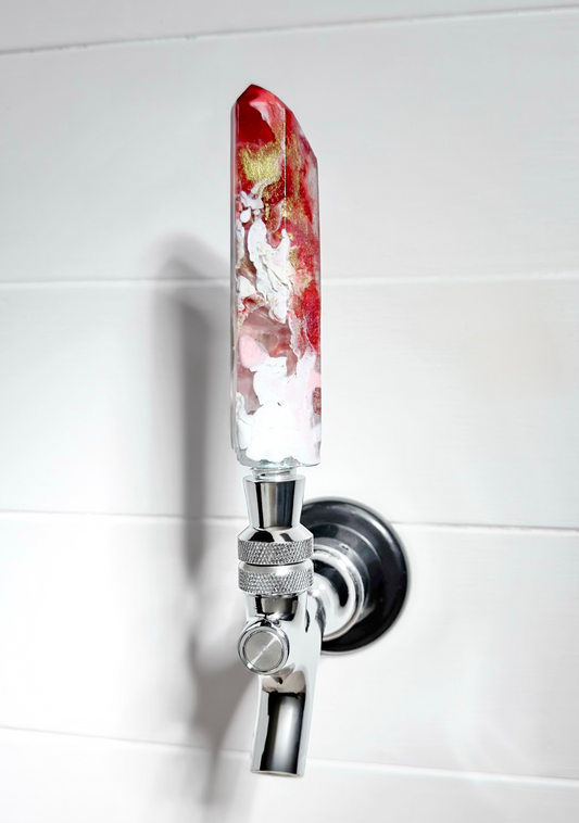 Handmade red, gold, pink, and white resin beer tap handle in a crystal shape