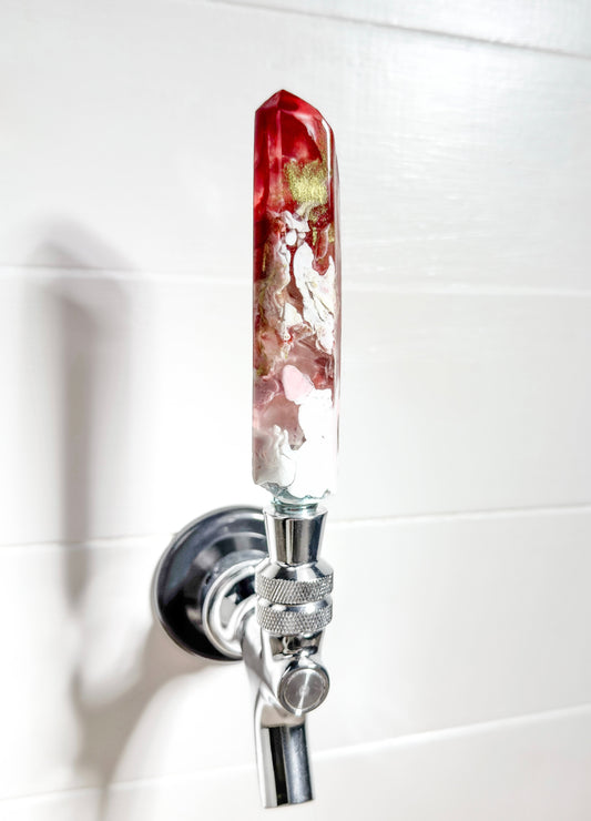 Handmade red, gold, pink, and white resin beer tap handle in a crystal shape