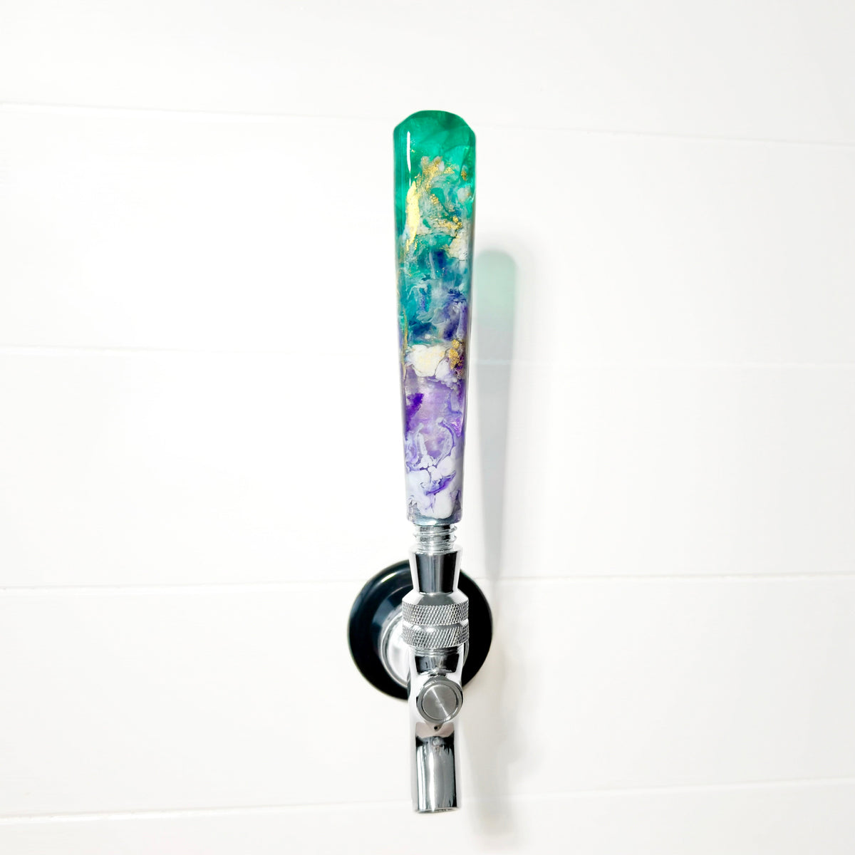 Decorative beer tap handle with a colorful design on a white background