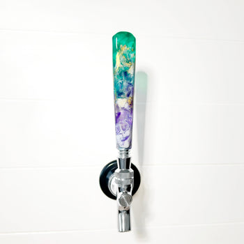 Decorative beer tap handle with a colorful design on a white background
