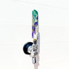 Decorative beer tap handle in purple and green with a white background
