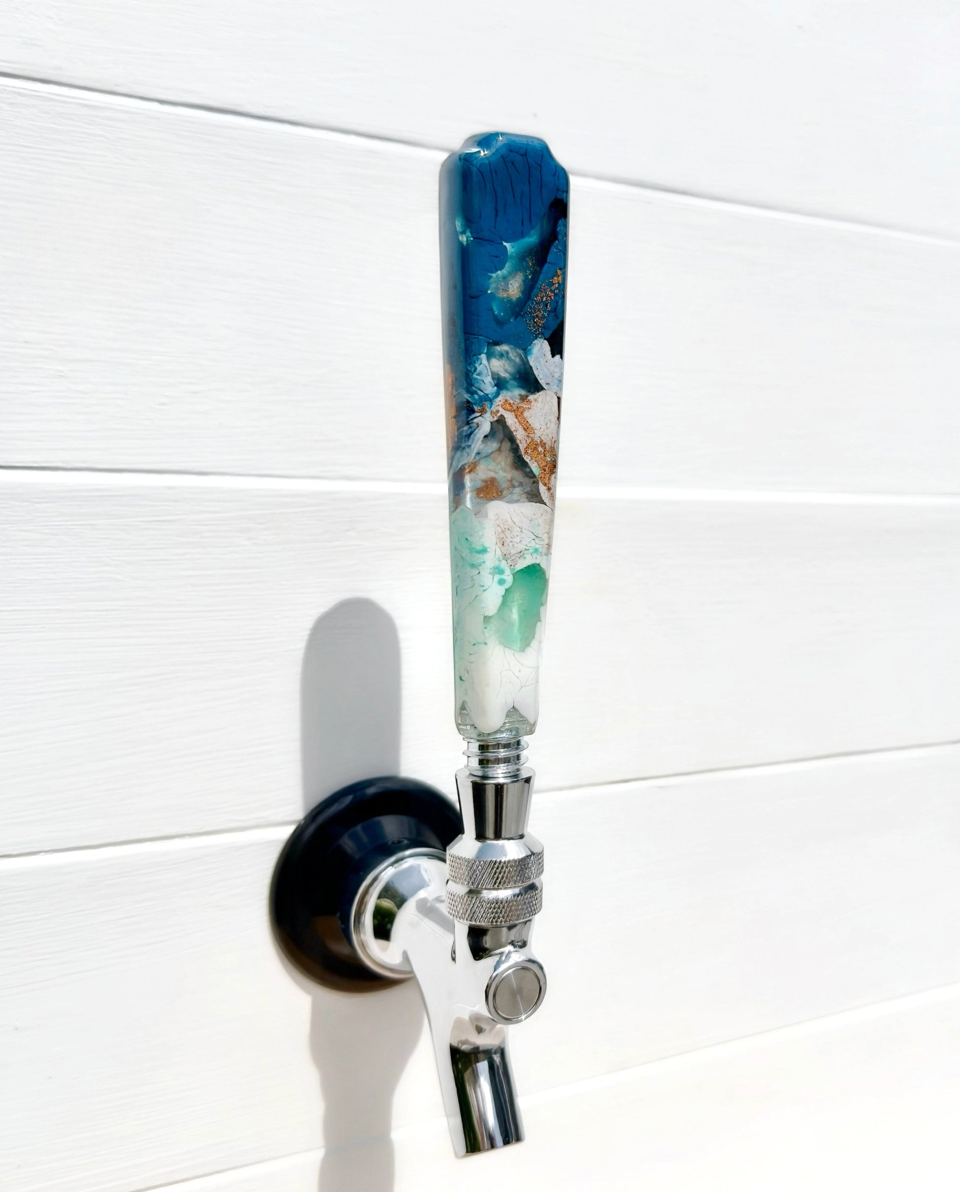 Handmade resin beer tap handle in deep teal, mint, white, and earthy bronze