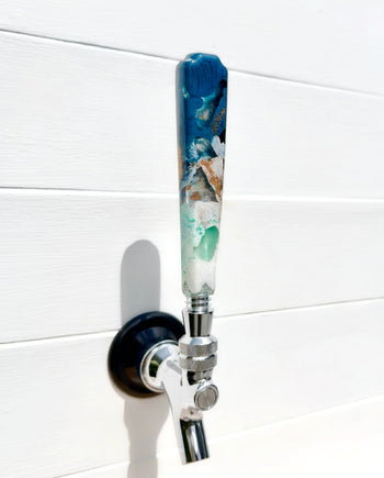 Handmade resin beer tap handle in deep teal, mint, white, and earthy bronze
